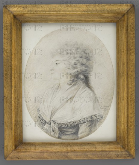 Portrait of an Elderly Woman in Left Profile, Taubert, Gustav Friedrich Amalius 1755–1839, en grisaille. Half-figure in left profile with a silver-white wig; shade of rouge on the lips and cheek. White fichu on the shoulders; greyish dress with brownish reflections. Background: natural color of the paper, accentuated with a pencil line and brown crayon. Binding: secondary, narrow wooden strip. Inscription bottom right: Gus: Taubert/Warsowi/1796. Miniature, 1796, Warsaw; height 10 cm, width 8 cm., A framed oval portrait drawing shows a left-facing bust of a person with light curly hair piled high and tied at the back, wearing a draped garment with a tied knot at the front and a textured trim along the edge; the drawing is rendered in shades of gray and black on a pale background, and the frame is wooden with warm brown and golden tones.