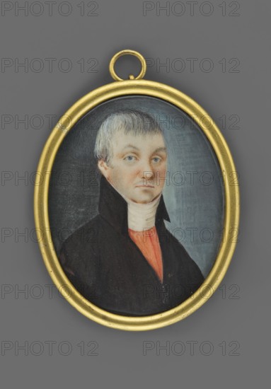 Kisiel great-grandfather Michal, Kisiel, Bar Confederate, painter unknown, three-quarter portrait of a man nobility, Polish miniature, circa 1800. Bust facing right: grey hair, blue eyes, white cravat, red vest and dark brown frock coat. Background dark grey left, blue right. Oval gilded bronze roller rim binding with convex glass. Inscription on reverse of miniature: Kisiel/pradziad; on reverse of binding: ?/Kisiel. Dimensions: height 5.0 cm, width 3.8 cm. Historical note: Michal Kisiel — captain with the banner of the 3rd Regiment of the Advance Guard of the Crown Field Mace in 1791; Bar Confederate; after the fall of Wawel Castle in 1769 he was taken prisoner by the Russians and spent five years in Siberia., An oval portrait in a gold frame shows a person with short light gray hair and pale skin wearing a high dark collar over a white neck wrap and a red-orange garment underneath; the background is a muted gradient of dark gray to blue-gray and the visible colors include gold, gray,...