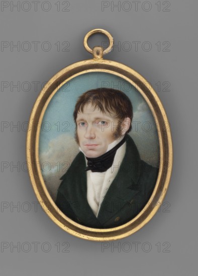 Samuel Bogumil Linde 1771–1847, painted by Giuseppe Landolfi fl. 1818–1823. Oval miniature portrait, bust three-quarters left: dark hair, sideburns; white collar, pleated jabot and white waistcoat; black cravat tied with a bow; dark green tailcoat with two rows of gold buttons. Background: dark clouds below, sky above. Semi-convex oval rim of gilded bronze. Signed on the left: Landolfi 1818. Inside the binding, mid-19th-century inscription: Samuel Bogumil / Linde / aged 47 / painted in Rome. / G. Landolfi. Below in contemporary hand: 1818. Miniature, height 7.4 cm, width 5.8 cm., An oval miniature portrait set in a gold-toned frame shows a man with light skin and brown hair styled with sideburns, wearing a dark green coat, a white shirt with a high collar, and a black cravat; his expression appears neutral and his eyes are light blue. The painted background is a soft blue with pale cloud-like shapes, and the outer background surrounding the frame is a medium gray. The visible colors in...