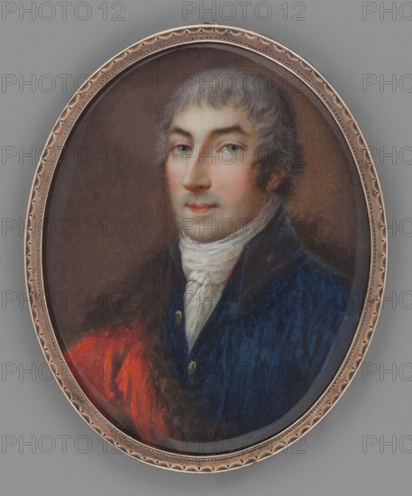 Szczesny Jerzy Potocki from Tulczyn 1776–1809, unknown painter. 3/4 bust left; short grey powdered hair combed over the forehead a la Caracalla/Titus, heavily rouged. White cravat, navy blue tailcoat with black collar and gold buttons, red coat trimmed or lined with brown fur. Background rusty brown, lightened on the right near the head. Miniature, 1800–1803. Height 7.1 cm, width 5.7 cm., An oval framed portrait of a man shown from the chest up, with light skin, grayish hair, and light-colored eyes, wearing a high white neckcloth, a dark blue coat with visible buttons, and a reddish garment draped over one shoulder; the background is a muted brown, the frame is metallic with a patterned edge, and the overall colors include blue, red, white, brown, gray, and metallic tones.