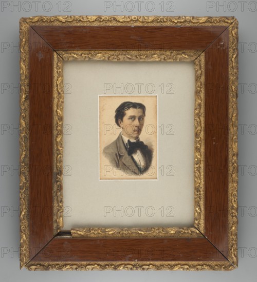 Zygmunt Sidorowicz 1846–1881, Lviv landscape painter; self-portrait?; artist in costume, three-quarter male portrait, Polish miniature, ca. 1870. Bust facing right. Black hair, short, parted in the middle; blue eyes. White shirt, black tie, blue vest, grey frock coat. Background: paper color. Miniature, height 9.3 cm, width 5.8 cm. Poorly legible inscription on reverse: Ka.la.owka / Nabielaka R.27 / 19/3 1859. Frame: ash-gray passe-partout in a wooden frame, decorated with classicizing ornaments in gilded plaster. Locations associated with the artist: Munich Germany, Vienna Austria, Lviv Ukraine., A framed painted portrait of a young person set within a wide mat and ornate frame. The portrait shows a head and upper torso with dark hair, a neutral facial expression, a dark bow at the neck, and a jacket and shirt in muted tones. The mat surrounding the portrait is a light gray-beige color. The frame has a glossy dark brown wood inner band and an outer decorative gold band with carved scr...