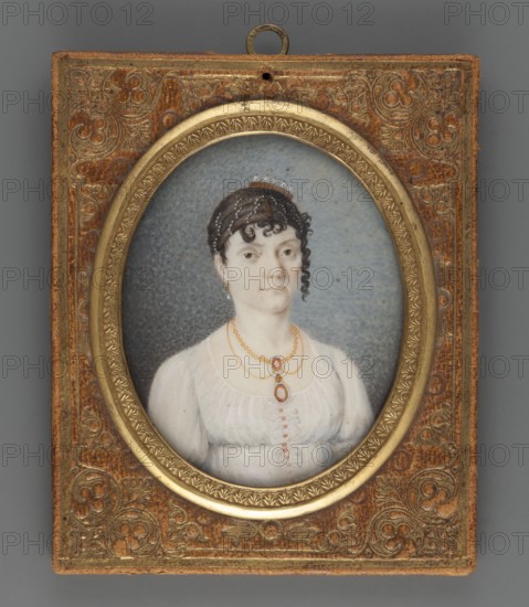 Baroness Schwerin, Martina Törngren von Schwerin? 1789–1875, Swedish writer; miniature portrait, 1809; full-length female portrait of nobility; amateur painter possible author; height 6.5 cm, width 4.0 cm; ., A framed oval portrait of a woman set in a rectangular ornate leather backing with decorative embossed patterns in brown and gold; the oval frame is a metallic gold with a textured floral border. Inside the oval, a woman with pale skin and dark brown hair styled with small curls and a longer ringlet at one side wears a white high-waisted dress with a gathered bodice and short sleeves. She has a pair of drop earrings and layered gold necklaces with oval pendants that have orange-red accents. The portrait background is a muted bluish-gray with a subtle textured appearance. The leather backing shows worn areas and varied shades of brown and the metallic elements show gold and aged patina.