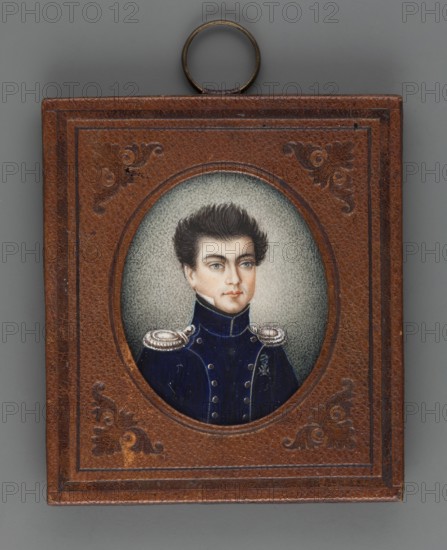 Captain of the Riflemen Józef Maciej Wentzl? 1796–1857, unknown author, en face portrait of a man in a navy blue uniform with yellowish insets, silver buttons and epaulettes, wearing the Virtuti Militari cross. Bust slightly right; black hair, light blue eyes; white shirt collar and black cravat. Style: Polish miniature; amateur painter. Background ash gray, lightened on the right and around the head. Binding: rectangular frame with an oval cut-out of brown leather, two embossed borders at the edges, ornaments in the corners. On the reverse of the binding: inscriptions reading Józef Wentz'l with crossings-out, 1816? and Laniewski. Dimensions: height 4.2 cm, width 3.5 cm., A small rectangular frame with a brown textured surface and embossed decorative corners surrounds an oval portrait; inside the oval is a portrait of a young person with dark brown hair styled upward, pale skin, light blue eyes, and a neutral expression, wearing a dark blue military-style coat with high collar and silv...