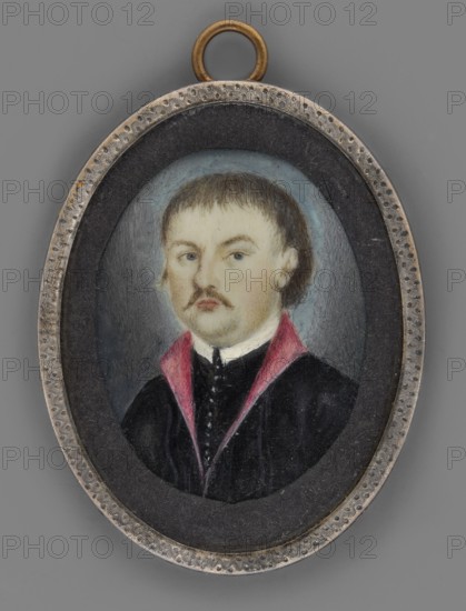 Teofil Wisniowski 1805/6–1847, participant in the November Uprising and Carbonari in Galicia; painter amateur. Three-quarter portrait of a man; miniature, height 4.9 cm, width 3.8 cm; dated circa 1840, Poland. Bust slightly turned to the left. Dark blond hair and mustache, gray eyes. Wears a white collar, black zupan with a row of silver buttons, and a black kontusz with magenta lapels. Background ash gray, lightened around the head. Frame: mismatched oval rim of zinc-plated silver; convex glass. On the reverse of the binding a label inscribed: Teofil Wisniowski / executed in Lviv on Execution Hill in 1846. Historical notes: emigrant, publicist, social activist; participant in the November Uprising 1830–1831 and organizer of the 1846 underground uprising in Galicia; in 1846 commander of a unit fighting Austrians near Narajów; captured by two Rusyn peasants, handed to the Austrians, arrested, sentenced to death and hanged in 1847 on a hill near Lviv known thereafter as Death Hill., An o...