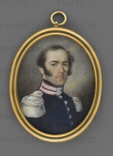 General Karol Zielinski 1787–1835, unknown artist, portrait en trois-quarts of a man; miniature 1830, Poland. 3/4 bust turned right; high forehead, black wavy hair, sideburns, brown eyes. Wearing navy blue uniform with amaranth collar, silver patches, silver buttons and epaulettes. Dark grey background lightened around the head. No frame. Oval bronze plate at bottom with a braid of dark-blond hair glued to it. Dimensions: height 5.5 cm, width 4.5 cm., An oval miniature portrait set in a gold frame shows a man with dark brown hair and prominent sideburns wearing a dark blue uniform with white and red collar details and decorative white shoulder epaulettes; his expression is neutral, his skin is light, and the background behind him is a muted gray with soft shading.