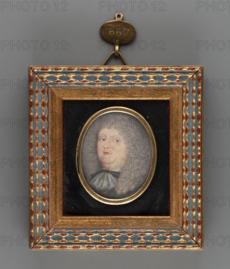Portrait of Frederick VI, Margrave of Baden Durlach 1617–1677. Engravers: Kilian, Philipp 1628–1693 and Merian, Mattäus 1621–1687; young. Painter: Le Febure, Thomas 1636–1720. Shoulder-length male portrait, bust 3/4 left, wearing black clothing with a lace jabot and a fawn lion-style wig covering almost the entire background. Inscription on reverse of the binding: ...Le Febure... ..A/1672. Binding: narrow medallion rim of sheet metal, mounted in velvet and bordered with a decorative profiled gilt strip. Miniature, 1672. Height 3.8 cm, width 3.1 cm., A small framed oval portrait shows a person with pale skin and light gray curly hair, wearing a garment with a light-colored collar and darker clothing beneath; the face has a neutral expression. The portrait is set against a black background and surrounded by a thin golden oval mat. The rectangular outer frame is gilded with decorative borders featuring a repeating pattern in blue and red with gold highlights, and there is a small metal ha...