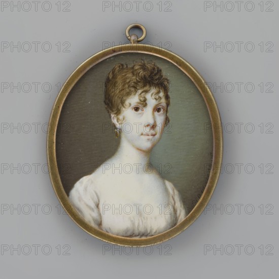 Portrait of a Young Woman in a White Dress, Auvigny, Charles d' 1760–1830 painter. Women; portraits en three-quarters; portraits of women; Polish miniatures; dresses; hairstyles; costumes; empire style. Portrait of a Woman, 3/4 bust facing right. Dark-blond hair piled up above the forehead with a few loose curls on the forehead and temples; a gold earring in her ear; white dress with a brown belt high at the waist. Background: grey-olive, lightened on the right near the face. Framing: medallion frame, double-sided, narrow oval gilded bronze border, hanging rings, no glass. Light pink glossy paper is placed under the miniature, giving a pinkish reflection to the face and shoulders through the bone plate. 1806, Poland. Miniature; height 6.3 cm, width 5.4 cm., An oval pendant with a thin brass-colored frame contains a painted portrait of a young person with short curly brown hair and light skin, wearing a white dress with a low neckline; the face shows neutral expression and the ears have...
