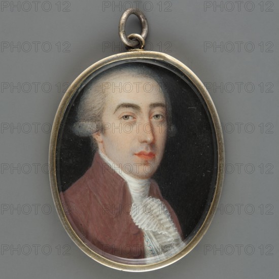 Portrait of a man in a brown tailcoat, aristocracy, costumes, men, three-quarter portrait, male portrait, foreign miniature; bust 3/4 right, gray powdered wig with a ponytail, white cravat and pleated jabot, white waistcoat with a patterned colorful trail, brown tailcoat bois de rose. Background: dark. Frame: narrow oval frame of gilded bronze. Ca. 1790, miniature, height 4.5 cm, width 3.5 cm., An oval pendant with a metal frame and loop encloses a painted portrait of a man from the chest up against a dark background; he has pale skin, powdered light gray hair styled back, light-colored eyes, and slightly red lips, and he wears a reddish-brown coat with a white high collar and a ruffled white cravat, with visible colors including gray, metallic silver, dark black, pale skin tones, light gray, reddish-brown, white, and a hint of pink on the lips.