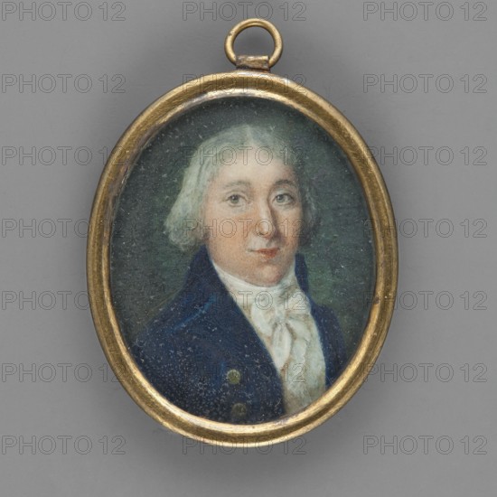 Portrait of a man in a navy blue tailcoat priest Tenishev?, unknown artist, three-quarter bust, male portrait, foreign miniature, amateur painter, ca. 1800–1820. Bust 3/4 right. Gray hair to ear level, parted in the middle. White cravat tied in a bow, white waistcoat. Sapphire tailcoat with gold buttons. Background gray. Narrow oval brass frame. Miniature, height 3.8 cm, width 3.0 cm., An oval pendant with a gold-colored metal frame contains a painted miniature portrait of a person shown from the shoulders up; the person has light grayish hair, a fair skin tone with subtle pinkish cheeks, and neutral facial expression with light-colored eyes; they wear a dark blue coat and a white neck scarf or cravat; the painted background is a muted dark green, and the outer background surrounding the pendant is a flat medium gray.