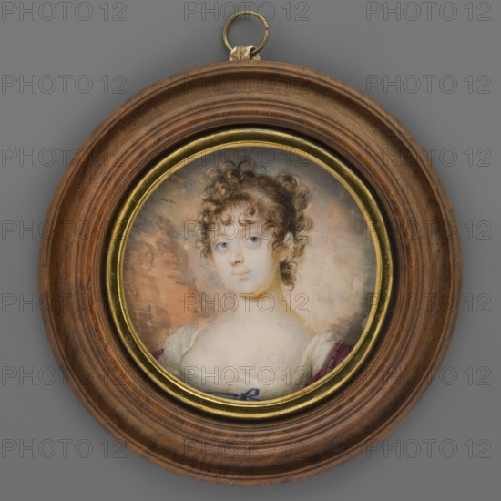 Portrait of a Young Woman in a White Empire Dress, Mainelli, Carl 1779–1838 painter. En face portrait of a woman, bust slightly to the left. Curly brown hair in a bun. Wearing a white Empire dress, bustiered, high at the waist, with a double sapphire ribbon tied in a bow and an amaranth shawl. Background grey-pink, damaged with water stains. Binding: secondary, contemporary, made of profiled wood polished to a walnut finish; brass rim on the inside. Colors largely faded so that only a sketch of the figure remains. Beneath the miniature: thin sheet of ducat gold sealed with paper and ownership numbers on the bottom: 5873 MN / Bat. 183 / 9477 Rew. On the reverse, cardboard box covered with dark cherry paper, with black paint on the bottom: 5873 MN. Dated ca. 1815. Miniature height 5.4 cm., A circular framed miniature portrait of a young person with pale skin and curly brown hair, shown from the chest up and wearing a light-colored garment with a darker shoulder drape; the face has blue e...