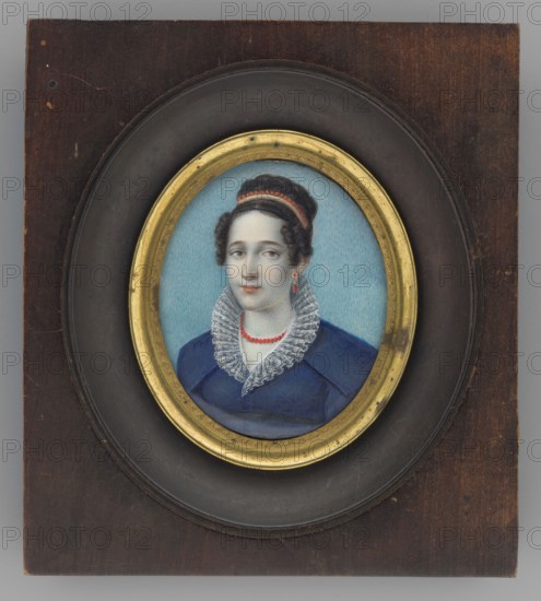 Portrait of a woman in a blue dress with a ruff, unknown artist, three-quarter portrait, costume, female portrait, Polish miniature, amateur, dated 1815–1830, miniature, height 5.6 cm, width 4.8 cm, A framed oval portrait of a woman set in a dark brown wooden plaque with a recessed black circular mat and a gold inner frame; the woman has dark brown hair styled up with a red band, pale skin, and neutral facial expression, wearing a blue dress with a high white lace ruffled collar and a red bead necklace, with a single red drop earring visible, and a light blue background behind her.