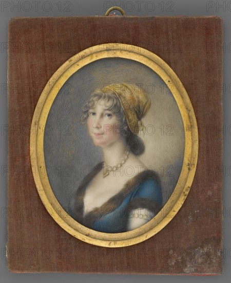 Portrait of a Woman in a Golden Bonnet, unknown artist, jewellery, aristocracy, women, costumes, headgear, three-quarter portrait, Polish miniature, dress, women's portrait. Bust 3/4 left. Gold bonnet, light ash-grey hair, gold ring earring in the ear; a necklace with a heart-shaped medallion and a bracelet on the left wrist made of gold hoops. The dress is dark blue, with brown fur at the neckline and on the sleeve. The background is gray, with highlights on the right near the head and left shoulder. Binding: an oval medallion frame made of gilded bronze in a rectangular frame covered with worn, dark rust-colored plush. Józef Choynowski, ca. 1803, miniature, height 7.3 cm, width 5.8 cm., An oval framed portrait of a woman set against a textured rectangular backing; the frame is gold and the backing is a reddish-brown fabric. The woman faces slightly to her right with a pale complexion, rosy cheeks, and light blue eyes; her hair is light brown with curls at the forehead and darker hair...