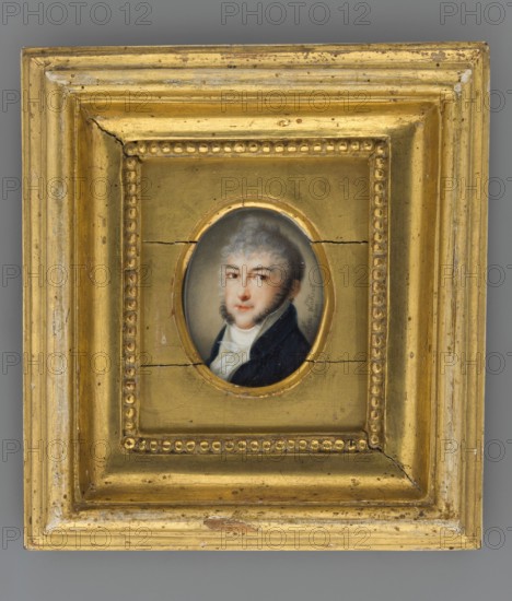 Michal Kleofas Prince Oginski of Retowo 1765–1833, composer, statesman, politician; miniature portrait by Nanette Haas Windisch 1790–1820, three-quarters view; subject: male portrait of a composer/statesman/politician; related figures: Oginski, Grzegorz Antoni 1654–1709; stylistic/historical context: artists, aristocracy, portraits, foreign miniatures, composers, Bar Confederation 1768–1772; date/place: 1807, Vienna; medium/format: miniature; dimensions: height 4.7 cm, width 3.6 cm., A small oval portrait of a person with light skin and grayish hair set within an ornate rectangular frame; the frame is predominantly gold with worn areas showing a paler underlayer and small dark spots, and it features a raised beaded inner border and stepped moulding; the portrait shows the person wearing a dark blue coat and a white cravat, with visible facial hair along the jaw, and a neutral expression against a muted grayish background; the frame has hairline cracks and areas of chipped gold revealin...