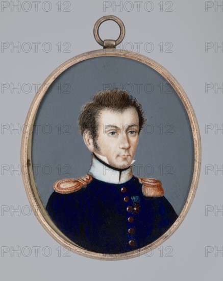 Lieutenant of the 4th Infantry Regiment, 1809–1810, Poland; miniature; height 6 cm, width 5 cm., An oval pendant with a metal frame contains a painted portrait of a man shown from the chest up against a muted gray background; he has light skin, brown hair styled upward, and visible sideburns, with a neutral expression and blue-gray eyes; he wears a high white collar and a dark blue uniform with gold or copper-colored epaulettes and buttons, and a small dark ornament on the chest; visible colors include gray, blue, white, brown, gold/copper, and flesh tones.