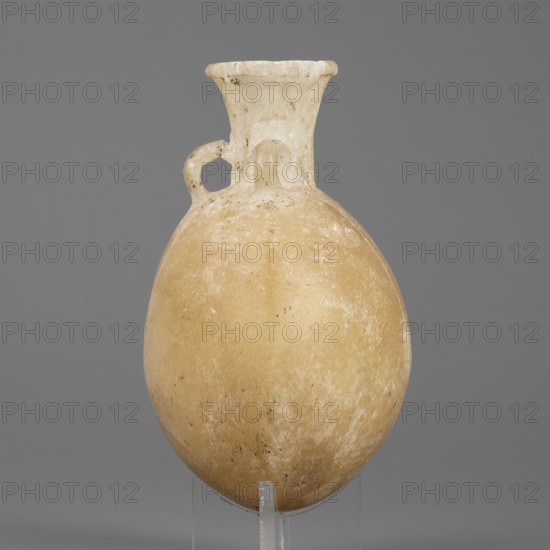 Flask-shaped vessel with a spherical, flattened belly, narrow widening neck and three small ring-shaped handles; stone; ca. 1550–1186 BC, New Kingdom, 18th–19th Dynasty, Egypt; height 8.8 cm, width 6.1 cm, weight 0.15 kg; pilgrim flask., An off-white to beige rounded vessel with a narrow neck and flared rim, showing a small looped handle near the neck; the surface has a weathered, slightly mottled texture with pale cream and tan tones and some darker specks, all set against a mid-gray background.
