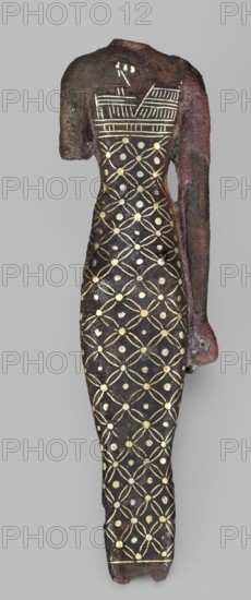 Figurine of a goddess, Neith mythology, female figurine, Egyptian deity. Standing woman in a narrow dress with straps; dress decorated with a mesh motif with rhombus dots; straps decorated with vertical and horizontal stripes. A necklace is worn. Head, feet, and left hand missing; right hand hangs alongside the body. c. 945–c. 715 BC; Third Intermediate Period, 22nd Dynasty, Egypt. Terracotta, figurine, height 11.3 cm, width 3 cm, weight 0.19 kg., A slender, elongated figure-shaped object with a dark brown to black surface, showing metallic gold decorative lines and dots in a repeating geometric pattern across the body; the upper portion includes a rectangular band of gold linear motifs near the shoulders, and the right side has a long arm-like extension with reddish-brown and greenish corrosion tones; the surface shows areas of rough texture and patina with hints of reddish and green colors against a neutral gray background.