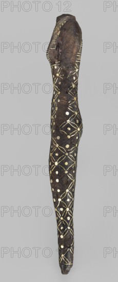 Figurine of a goddess, Figurine of a standing woman in a narrow dress with straps. The dress is decorated with a mesh motif with rhombus dots; the straps are decorated with vertical and horizontal stripes. A necklace is worn on the neck. The head, feet, and left hand are missing; the right hand hangs alongside the body. Possibly Neith mythology. Egyptian deities; Egyptian religion; Egyptian art. c. 945–c. 715 BC; Third Intermediate Period, 22nd Dynasty, Egypt. Terracotta, figurine, height 11.3 cm, width 3 cm, weight 0.19 kg., A narrow, elongated object resembling a limb with a rounded top and tapering bottom is shown against a plain gray background; the surface of the object is dark brown to near black with a textured, worn appearance and is decorated all over with a repeating pattern in metallic gold, consisting of circular dots connected by petal-like shapes forming a lattice; the top area shows a slightly different banded gold decoration near the rounded end, and small variations in...