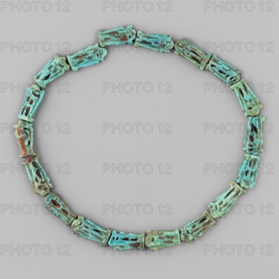Necklace of 18 amulets, ankhs, uas iconographic, ca. 1550–1295 BC; New Kingdom, 18th Dynasty, Egypt; amulet jewelry, height 27 cm; maker, Goluchów Greater Poland Voivodeship provenance., A circular arrangement of a group of small carved bead-like objects forming a necklace shape, each bead shaped like a narrow rectangular cylinder with cutouts and irregular edges, displaying a mix of turquoise, aqua, green, brown, and hints of darker patina, set against a light gray background.