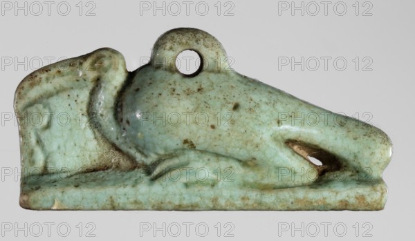 Amulet - ibis, amulet depicting an ibis, bird pendant, sacred animal associated with Egyptian religion, Late Period, 664–332 BC, Egypt; height 1.7 cm, width 3.6 cm, A small sculpted object shaped like a reclining animal with a rounded back and elongated snout, rendered in a pale green glaze with a network of fine cracks and scattered brown speckling; the surface shows areas of darker brown discoloration and worn spots, a circular hole near the top of the back, and a darker recess within the mouth area; the piece rests on a flat base that shares the same pale green and mottled brown coloration.