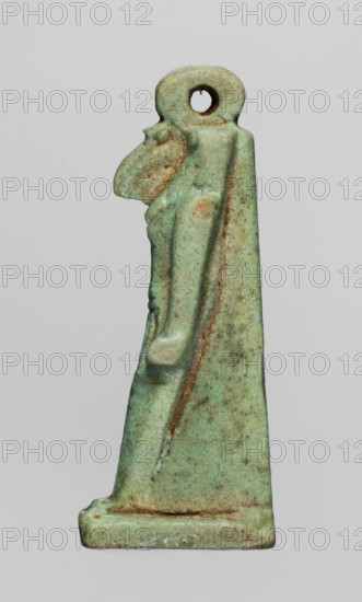 Amulet — god Thoth; made of green faience; Egyptian, Late Period 664–332 BC; subject: Thoth Egyptian deity, Egyptian religion; amulet; height 5 cm, width 1.3 cm;, A small carved figurine with a triangular, tapered form standing on a rectangular base, showing a stylized human figure in profile with a pronounced beak-like head and a rounded loop at the top, rendered in a weathered green with patches of brown and lighter greenish-blue, and textured surfaces with areas of darker speckling and worn edges.