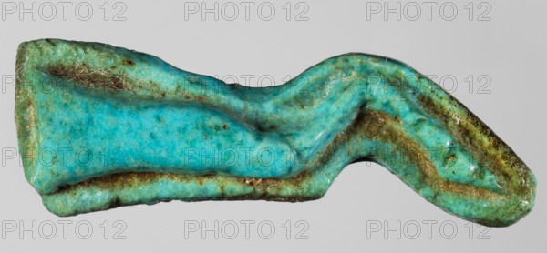 Amulet - ox leg khopesh, offerings, amulets - body parts, animals, grave goods, ca. 1550–1295 BC; New Kingdom, 18th Dynasty, Egypt, amulet, height 4.1 cm, width 1.4 cm, A roughly elongated, irregular object with a wavy, folded shape occupying the frame, showing a textured surface with visible pitting and creases; the predominant colors are turquoise and aqua with areas of greenish patina and patches of brown discoloration, plus a few pale off-white fibrous threads caught on the surface; the background is a uniform light gray.