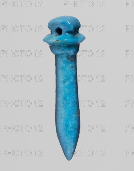 Amulet in the shape of a scepter topped with a papyrus canopy. Amulet; papyrus scepter. 664–525 BC; Late Period, 26th Dynasty, Egypt. Height 2.5 cm; width 1.9 cm., A single small object photographed against a plain light gray background, shaped like a long tapered spike with a rounded pointed end and a wider top that flares into a short collar beneath a rounded cap with a circular hole; the surface shows a glossy finish with a few tiny pits and imperfections and subtle variations in tone; the predominant color is bright turquoise blue with areas of slightly darker blue and occasional small spots of muted brown.