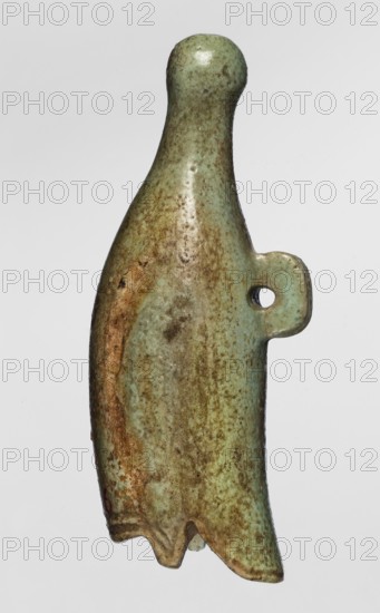Amulet — white crown; maker, found in Goluchów Greater Poland Voivodeship; amulet in the shape of a white crown with a pendant on the back; 664–525 BC, Late Period, 26th Dynasty, Egypt; amulet; height 5.6 cm, width 1.5 cm, A small sculptural object with a smooth, rounded top and a tapered, curved body that widens slightly near the bottom, featuring a small rounded tab with a circular hole on one side; the surface shows a mottled mix of green and brown tones with patches where the green is paler and areas of darker brown and rust-colored mottling; the texture appears slightly pitted and worn, and the bottom edge has an irregular, scalloped shape.