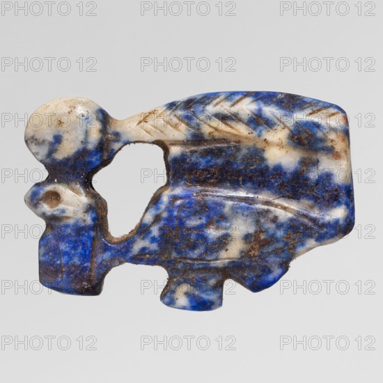 Amulet — Udjat eye with Uraeus; maker, Udjat eyes, Uraeus, symbols of Egyptian religion; New Kingdom, 18th Dynasty, ca. 1550–1295 BC; material/technique: amulet; dimensions: height 2.6 cm, width 1.7 cm., A small carved object with an irregular outline, showing a mix of blue, white, and brown colors across its surface, with mottled and speckled patterns; the piece has smooth rounded areas and carved linear grooves creating a feather-like texture in places, plus a few rounded protrusions and a hollowed opening near the center, with visible surface wear and some rough, darker patches.