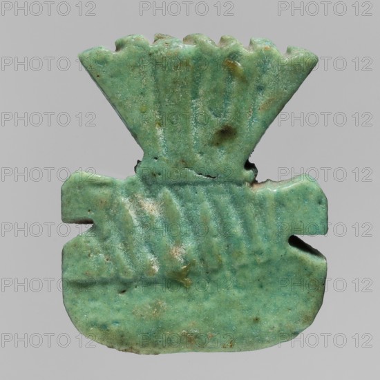 Amulet plaque with the head of the god Bes, amulet in the form of a plaque with a relief depiction of the face of Bes, with a fan of feathers on the head and decorative curls of beard on both sides of the chin; crowns; plaques; Egyptian deities; Bes myth.; Late Period, Egypt, 664–332 BC; height 3.8 cm, width 4.1 cm, A small carved object with a greenish-blue surface showing variations of turquoise and hints of darker green and brown spots, shaped with a wider rounded lower section and a flaring toothed upper section, featuring shallow ridged grooves across its middle and top areas, a few small chips and rough edges, and a smooth but slightly pitted texture against a plain light gray background.