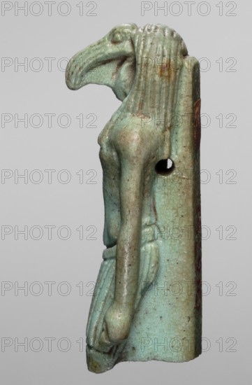Amulet - god Thoth; maker, Thoth myth., Egyptian deities, Egyptian religion; dated 664–525 BC, Late Period, 26th Dynasty, Egypt; amulet; height 5.2 cm, width 2.1 cm, A small sculpted figure viewed in profile with a stylized bird-like head and elongated beak, a slender upright torso, and long straight arms hanging alongside a simple wrapped skirt; the surface shows a worn, glazed appearance in shades of turquoise and pale green with areas of brown and darker speckling, and there is a vertical back piece attached with a circular hole visible near the shoulder.