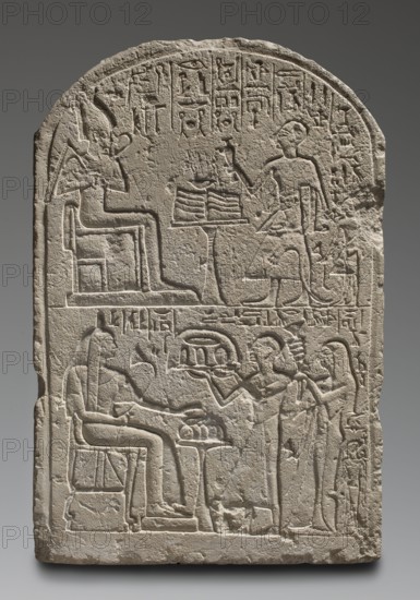 Votive stela of the priest Peraaerneheh. The stele decoration is arranged in two registers. The upper register depicts Osiris seated on a throne at an offering table, in front of whom stands a priest dressed in leopard skin, holding a censer and a ritual vessel, and behind him a second figure on a smaller scale. In the lower register, three people—a married couple and their daughter—bring offerings a tray of bread and a bouquet of flowers to a lady seated in a lion-pawed chair next to a small table with loaves of bread. Inscriptions include sacrificial formulas and hieroglyphs naming Peraaerneheh ca. 1295–1184 BC and associated persons Tia; Maya; Pianefer; Medjeri; Ta-miu; Ankh. Iconography: offerings, atef crown, lotus, censer, nechacha whip, heka scepter, offering tables, throne, priests, religious/grave equipment scenes. Date: c. 1295–c. 1186 BC, New Kingdom, 19th Dynasty, Saqqara. Material/format: stele; height 57.5 cm, width 38.5 cm, depth 9.5 cm, weight 33 kg., A carved stone ste...