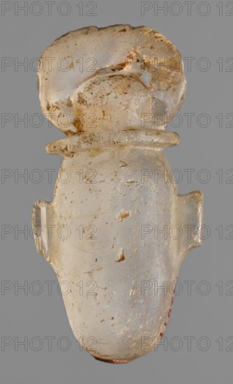 Amulet - heart with a sun disc;, sun disc iconography; protective amulet and grave good; Late Period, Egypt, 664–332 BC; heart-shaped amulet; height 5 cm, width 2.5 cm, depth 1.5 cm., An off-white translucent object with a smooth, rounded top and a bulbous body, showing areas of rough texture and surface wear with small patches of brownish discoloration and a few yellowish spots; the object has a flat collar-like ridge below the rounded top and small protruding tabs on either side of the body, all photographed against a uniform gray background.