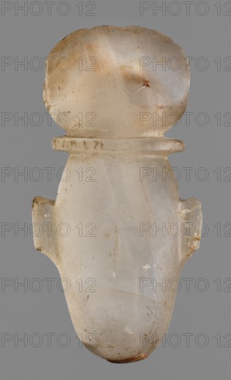 Amulet - heart with a sun disc;, sun disc iconography; grave goods; protective amulet; Late Period, Egypt, 664–332 BC; amulet; height 5 cm, width 2.5 cm, depth 1.5 cm, A translucent, rounded object with a bulbous top and a tapered lower body is shown against a solid gray background, appearing to be made of a milky, off-white material with areas of pale beige and faint amber tones, and small patches of brown discoloration. The surface shows a few rough spots and minor chips, with subtle striations and cloudy internal variations in color. There are small protrusions on each side near the middle, and a thin flange-like ridge below the bulbous top. Overall the colors visible are off-white, beige, pale amber, brown, and gray.