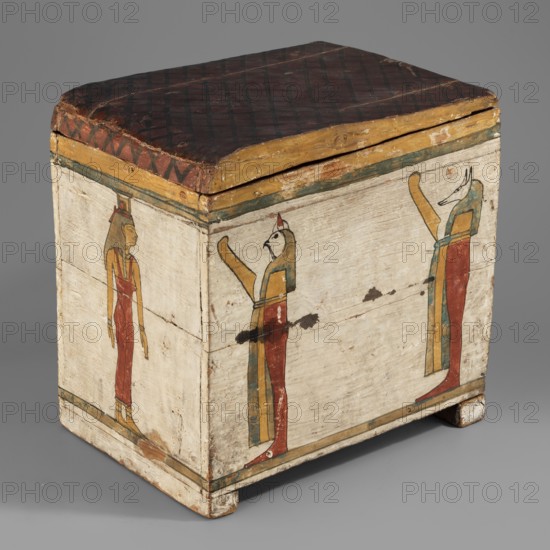 Canopic box, Sons of Horus mythology, falcons, jackals, Isis mythology, Nephthys mythology, grave goods, Egyptian deities; ca. 747–656 BC, Third Intermediate Period, 25th Dynasty, Egypt. Canopic box; height 28.5 cm, width 22 cm, depth 29 cm., A painted wooden chest with a hinged lid sits on small block feet; the lid is dark reddish-brown with a darker crosshatch pattern and a yellowish edge, and the sides of the chest are painted a pale off-white. On the front and side panels there are a few standing humanlike figures rendered in flat profile with elongated limbs and stylized heads; their garments and headdresses show colors including red, yellow, green, blue, and brown. The chest surface shows areas of wear and chipped paint, with some exposed wood and darker scuff marks, and thin horizontal bands in green and yellow run near the top and bottom edges. The background is a smooth neutral gray.