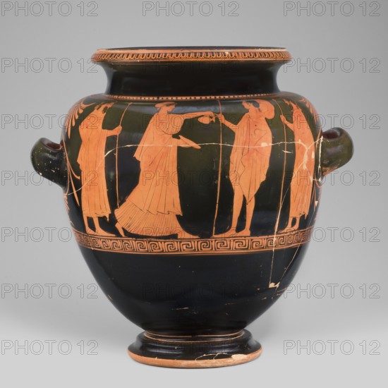 Stamnos with a depiction of Boreas and Oreithyia, unknown Attic workshop; Oinochoe Painter 480–460 BC; Orithyia mythology, Boreas mythology; Greek pottery, 470–460 BC; Attica; vessel stamnos; weight 3.556 kg; height 34 cm; diameter 29.1 cm; width 36 cm with vices; diameter of outlet 22 cm., A rounded ceramic vessel with a dark background and a group of orange-figure human silhouettes encircling its shoulder, depicting several robed figures in profile engaged in gestures and holding slender staffs or vessels, a few figures facing each other as one extends an arm toward another. The vessel has a wide neck with a decorative band beneath its rim, a pair of horizontal handles on opposite sides, and a patterned band around the lower part of the decorated zone. The base and foot show the same dark color with orange edges and some worn areas, and the overall palette includes dark black or deep brown and warm orange tones.