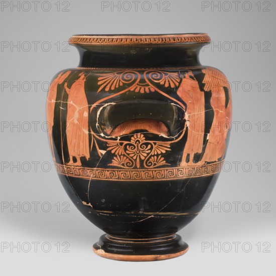 Stamnos with a depiction of Boreas and Oreithyia, unknown Attic workshop; Oinochoe Painter from Yale 480–460 BC; Orithyia mythology, Boreas mythology; Greek pottery, 470–460 BC; Attica; vessel stamnos; weight 3.556 kg; height 34 cm; diameter 29.1 cm; width 36 cm with vices; dia. outlet 22 cm., A rounded ceramic vase with a narrow foot and flared rim, primarily black with orange-red painted figures and decorative motifs; a group of standing draped female figures in orange-red appears on the upper body, flanking a central recessed handle area that is surrounded by scroll-like and palmette ornament in orange-red; a band of geometric key-pattern decoration encircles the vase below the figural scene, and the lower body is mainly black with some orange-red wear and chips at the base; the rim has an orange-red decorative border and the surface shows fine cracks and restoration lines.