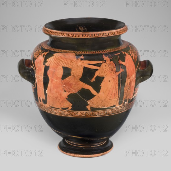 Stamnos with a depiction of Boreas and Oreithyia, unknown Attic workshop; Oinochoe Painter 480–460 BC; Scen. Gal. Class.; Orithyia mythology, Boreas mythology; Greek pottery, 470–460 BC; Attica; vessel, stamnos; weight 3.556 kg; height 34 cm; diameter 29.1 cm; width 36 cm with vices; dia. outlet 22 cm., A rounded ceramic vase with two handles sits against a light gray background; the vase has a glossy black surface with a band of orange-red figures and decorative patterns around its shoulder and midsection, showing several human-like figures in profile with flowing garments and wings, rendered in orange-red against the black, and additional orange-red ornamental borders and motifs near the rim and base; the handles and interior appear black, while the orange-red decoration shows areas of wear and spotting.