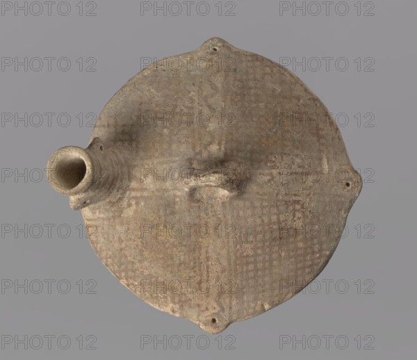Askos., Cyprus, 1900–1650 BC. Cypriot White Painted Ware III–IV. Terracotta reddish clay with creamy engobe, painted in matte reddish-brown. Vessel askos, height 6 cm, diameter 9.5 cm. Askos with a slightly concave bottom. Lower part of body spherical, separated from upper by a distinct sharp edge, from which protrude four small projections each with a small hole. Upper surface gently rounded; central ring-shaped boss mounted along axis of neck. Cylindrical neck with asymmetrically mounted projecting spouts with holes on both sides, analogous to those on edge of body. Rim very slightly flared. Decoration: neck surrounded by lines; upper surface shows a mesh between the arms of a Greek cross formed by two lines with a wavy line between them; the boss is painted. Below the edge of the body a wavy line bordered below by a straight line. Underside: a Greek cross with arms composed of four lines each; between the arms are single wavy lines extending from the center to the edge. Surface worn...