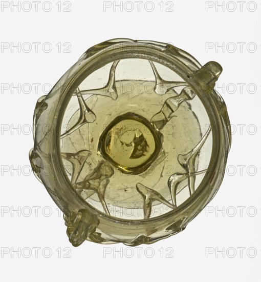Skyphos, Goluchów Greater Poland Voivodeship. Deep bowl with wide foot and two small vertical handles. Surface decorated with a zigzag ornament applied with irregular threads. 3rd–4th century AD, Roman Empire 27 BC–476. Vessel, height 11 cm., A top-down view of a translucent glass vessel in pale yellow-green with a rounded rim and a thicker central base, showing a group of raised teardrop-shaped protrusions attached to the interior sides and a few small external knobs on the outer edge; the glass surface has visible bubbles and slight irregularities, and the colors visible are pale yellow-green, muted amber, and hints of clear glass.