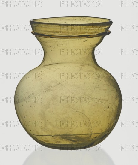 A viceless vessel, unknown,  author, Goluchów Greater Poland Voivodeship, Below the edge a glass thread is applied horizontally., unspecified, vessel, height 12.4 cm, width 10.7 cm, A translucent bulbous glass vessel in a yellow-green hue with a narrow neck flaring into a wide, slightly flattened rim, showing a thin applied glass ring around the neck; the surface contains a few visible bubbles and internal streaks, and the glass displays subtle variations in color from pale yellow to olive green with faint cloudy inclusions and scratches, set against a plain light background.