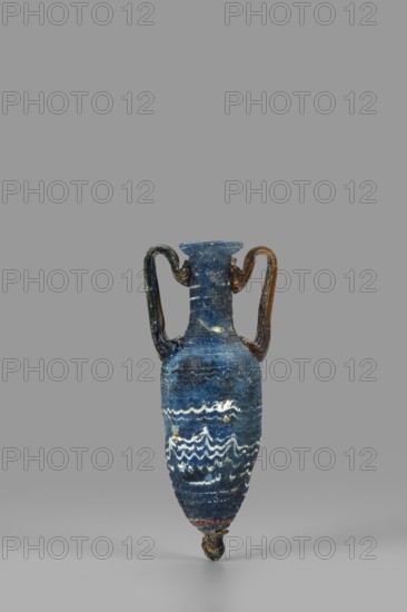 Amphorisko, Amphorisko with an ovoid belly, a long cylindrical neck ending in an uneven, slightly flaring rim, an uneven foot glued on, vertical, high, arched vises. Type: Grose III:E form III:2B, Harden form 7B. Opaque, dark blue glass decorated with white thread in a festoon pattern. The foot and vertical vises are made of dark amber, translucent glass; molding on the core. 2nd–1st century BC, Syria; vessel, amphorisko; rim diameter 2.8 cm; weight 0.110 kg., A small narrow vessel with a rounded body tapering to a pointed base and a short flared neck, featuring a pair of curved handles extending from the neck to the shoulder; the surface is predominantly deep blue with areas of lighter blue and white wavy decorative bands around the body, and the handles show darker brown and black tones with some glossy highlights, all set against a plain gray background.