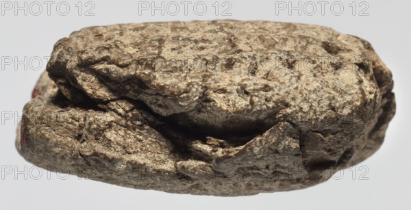 Cuneiform tablet with receipt, unknown Babylonian official role classification of creator, cuneiform tablets, Neo-Babylonian document, trade, Rectangular tablet, slightly convex, horizontally oriented. Three corners broken off; cracks on the lower and left sides; 9 lines of cuneiform text on the obverse, 2 on the lower side, 9 on the reverse. 6th century BC; Neo-Babylonian period, Babylonia Iraq, Southern Mesopotamia, administrative document, height 3.8 cm, width 4.5 cm, thickness 2 cm, A close-up view of a rough, irregular rock with a textured, layered surface in shades of beige, tan, brown, and gray, showing crevices and fractured edges; a few shadowed cavities and darker brown recesses contrast with lighter sandy areas, and there are small patches of muted reddish color visible near one edge, all set against a pale, neutral background.