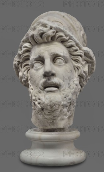 Head of Menelaus from the Menelaus Carrying the Body of Patroclus group, unknown artist. Head of a bearded man wearing a helmet, with an expressive face shown by wide-open eyes and parted mouth, emphasized by chiaroscuro effects from the contrast between lush locks of beard and hair emerging from under the helmet and the smooth skin of the face. This is the face of a man experiencing dramatic moments. The helmet is adorned with relief decoration depicting fantastic creatures: on each side a centaur fighting a Greek, and below, on the edge, a triton figurine. The sculpture is a Roman copy of the head from a Hellenistic bronze composition depicting Menelaus with the body of Patroclus. Menelaus, Helen's husband, is the first to fight to retrieve the deceased's body and then carries it from the battlefield for burial; the death of Patroclus, Achilles' friend, is an important moment in the Trojan War as it brings Achilles back into the fight. This theme was frequently reproduced in Roman sc...
