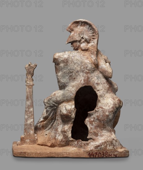 Athena figurine, Classical Gallic scenography, Athena mythology, Nike mythology, Greek deities, 4th century BC, Greece, figurine; height 16.5 cm, width 13.5 cm, depth 7.8 cm, weight 0.35 kg., A weathered figurative sculpture in earthy brown and beige tones showing a seated figure wearing a helmet with a crest, viewed from behind and slightly in profile; the figure rests one arm on a rocky form that has a hollowed-out cavity revealing a dark interior, and a draped garment with textured folds covers the figure and the rock; to the left of the figure stands a tall, slender column topped with an abstract form; the sculpture sits on a flat base against a plain gray background.