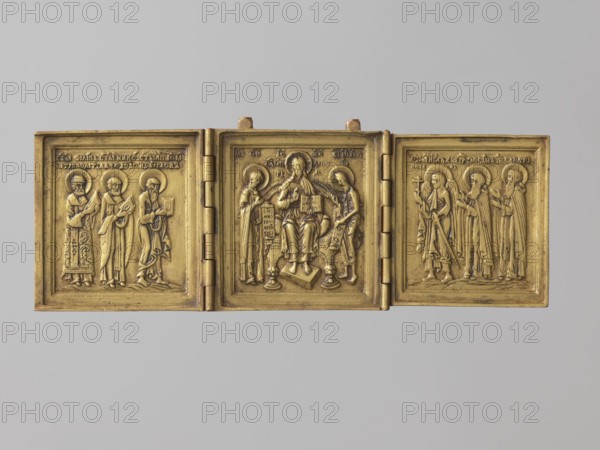 Triptych: Deesis with Saints Zosima and Savvatiy Solovetsky, Unknown Pomeranian Old Believers workshop probably. Deesis iconography with monks, John the Baptist, the Virgin Mary, Nicholas of Myra, Philip Metropolitan of Moscow, John the Theologian/John the Evangelist, Zosima Solovetsky, Savvatiy Solovetsky, Guardian Angel, instruments of the Passion, books, scrolls and inscriptions. Center: full-figure enthroned Christ with the Virgin Mary and John the Baptist addressing Him in prayer. Side wings: Metropolitan Philip of Moscow, St. Nicholas the Wonderworker, John the Theologian left; Guardian Angel with sword and cross, Zosima and Savvatiy Solovetsky right. Reverse: round medallion with eight-pointed cross on Golgotha. Relief executed with high precision but slight simplifications in facial features ascetic faces with broad noses and rounded eyes. Presence of the Guardian Angel is typical of Old Believer triptychs; inclusion of the Solovetsky founders indicates a northern Pomorian orig...