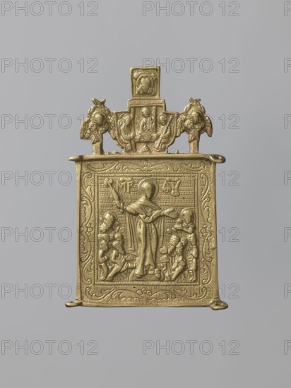 Middle wing of a triptych: Our Lady Consolation of All the Afflicted, Russian workshop, Mary mother of Jesus Christ, angels, Holy Trinity iconography, Mandylion iconography, Consolation of All the Afflicted iconography, cherubs, ornaments, inscriptions, people, maphorion iconography. The middle wing the side wings have not survived shows the Mother of God with outstretched hands, holding a cylindrical object a scepter in her right raised hand. People kneel at her feet on both sides, and angels stand behind them. In the background is a schematic geometric ornament on both sides of the Mother of God the letters of the Marian monogram, and in the frame a floral one. Above is an image of the Old Testament Holy Trinity between two cherubim, and above it the Savior Not Made by Hands. The cast relief is schematic and archaic. 18th century, Russia; icon; height 10.2 cm, width 6 cm., A small rectangular metal plaque in a gold color is shown against a neutral gray background, featuring a raised ...