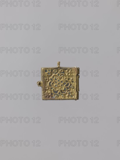 Diptych: Old Testament Holy Trinity and the Mother of God Znamienije, Old Believers' workshop; Mary mother of Jesus Christ; the Mother of God Znamienije iconographic; the Holy Trinity iconographic; angels; diptychs; the Mother of God with the Child iconographic; tree iconographic; mountain iconographic; inscriptions; Old Believers; maphorion iconographic; ; Golgotha iconographic. On the two wings of the diptych there are images of the Mother of God with Christ Emmanuel on her breast in a round medallion, and three angels sitting behind a trapeze. Identifying inscriptions are placed on both sides of the images. 18th–19th century, Russia; icon, diptych; height 3 cm, width 7.5 cm; 3 x 3.7 x 2., A small square metal object with a hinged edge and a tiny loop at the top, featuring an embossed floral-like rosette pattern in relief; the metal appears golden with areas of darker patina and small blue-green accents, all set against a plain light gray background.