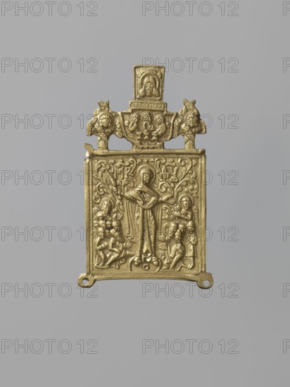 Central wing of the triptych: Mother of God Consolation of all the Sorrowful, Russian workshop, Mary mother of Jesus Christ, angels, Holy Trinity iconography, Consolation of all the Sorrowful iconography, Jesus Christ Bible, Mandylion iconography, maphorion iconography, ornaments, inscriptions, deposit, gift, Angels with Abraham iconography. In the centre the Mother of God is shown—an orant surrounded by praying people led by angels. Above is a medallion depicting the Old Testament Holy Trinity, framed by two cherubim, and above it the Mandylion. In the background a rich, though linear, floral ornament is visible, into which the letters of the Marian monogram are woven. 19th century, Russia, icon, height 9.1 cm, width 5.7 cm., A rectangular metal plaque with a raised relief design, shown against a plain gray background, appears in a gold color. The plaque features a central standing figure with a halo, arms outstretched, surrounded by a group of smaller human figures in various poses o...