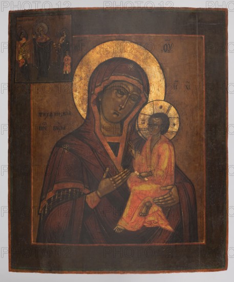 Icon: Our Lady of Tikhvin, Russian workshop. Our Lady of Tikhvin iconography, Mary mother of Jesus Christ, Consolation of All Who Sorrow iconography, Jesus Christ Bible, Our Lady and Child iconography, maphorion iconography, icons, angels, inscriptions, message. In the center of the icon is the Tikhvin image of the Mother of God. In the upper left corner is an inscription with the image Consolation of All Who Sorrow. The icon's form is linear and flat, with dark colors predominating—shades of brown, muted purple, and vermilion brightened with yellow. The faces are treated schematically; in the Consolation... scene there is a tendency toward synthesis and simplification: the scene is limited to the Mother of God in the center, standing with her arms outstretched, and four figures of the poor/suffering approaching Mary led by angels. No clasps. 19th century, Russia. Height 40.0 cm; width 33.8 cm., A painted religious image showing a seated adult figure holding a child figure against a da...