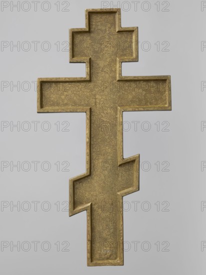 Cross: Crucifixion of Christ, Old Believers workshop; crosses; Jesus Christ Bible; angels; skull iconography; Adam Bible; Crucifixion iconography; moon iconography; sun iconography; instruments of the Passion of the Lord iconography; Jerusalem Israel/Palestine; Mandylion iconography; Golgotha iconography; Old Believers; inscriptions. The obverse shows Christ crucified on Golgotha. Below the cross in the grotto are Adam's skull and the tree of Seth; at the level of the footstool is a view of Jerusalem; on the crossbar are symbols of the sun and moon; in the upper part above the cross is the Mandylion and two angels descending toward Christ. The relief is decorative and very carefully crafted. The set of inscriptions and the font are typical of Bezpopovtsy Old Believer crosses. On the reverse is an engraved plant ornament typical of the Pomeranian environment. 19th century, Northern Russia; cross, height 38.5 cm, width 20.2 cm., A decorative object in the shape of a stepped cross with a ...